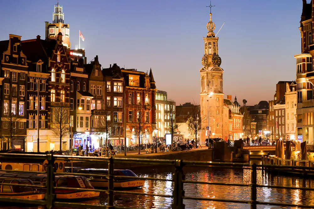 Amsterdam canals and clocktower at night