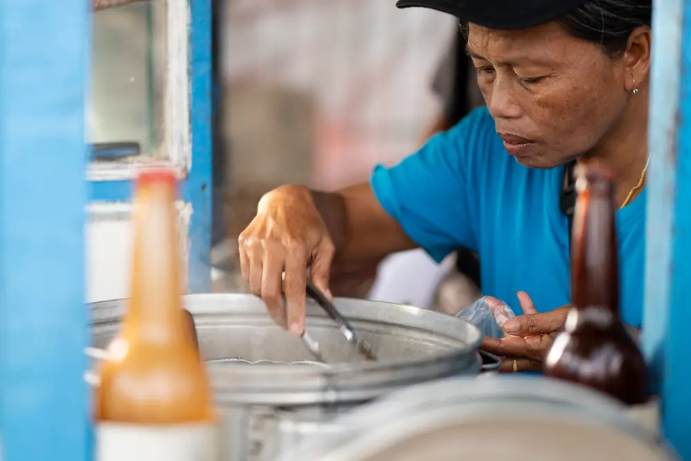 Vendor serving food in Bali, Indonesia